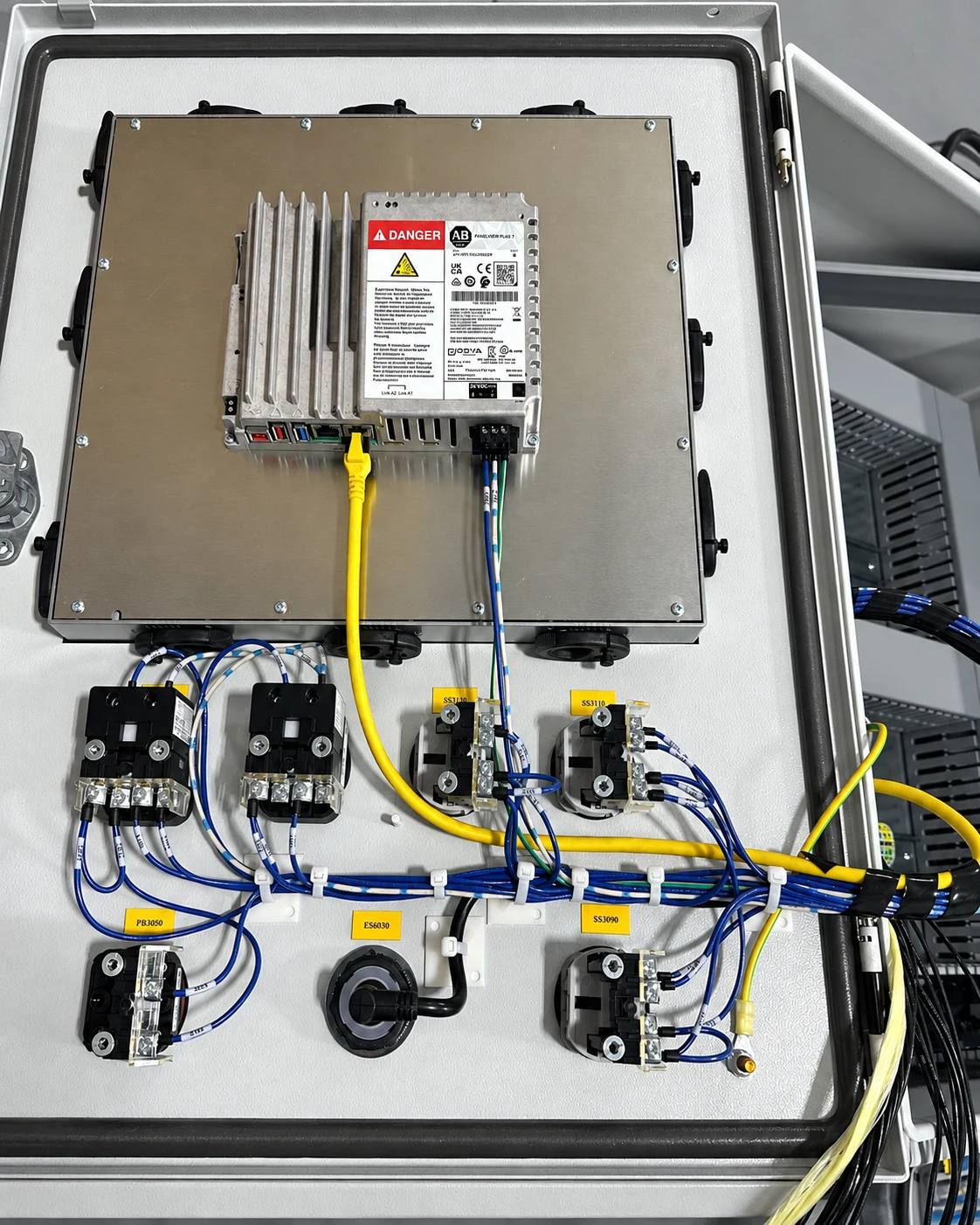 Inside of the control panel door with HMI connections, identified wires, and operator-device wiring